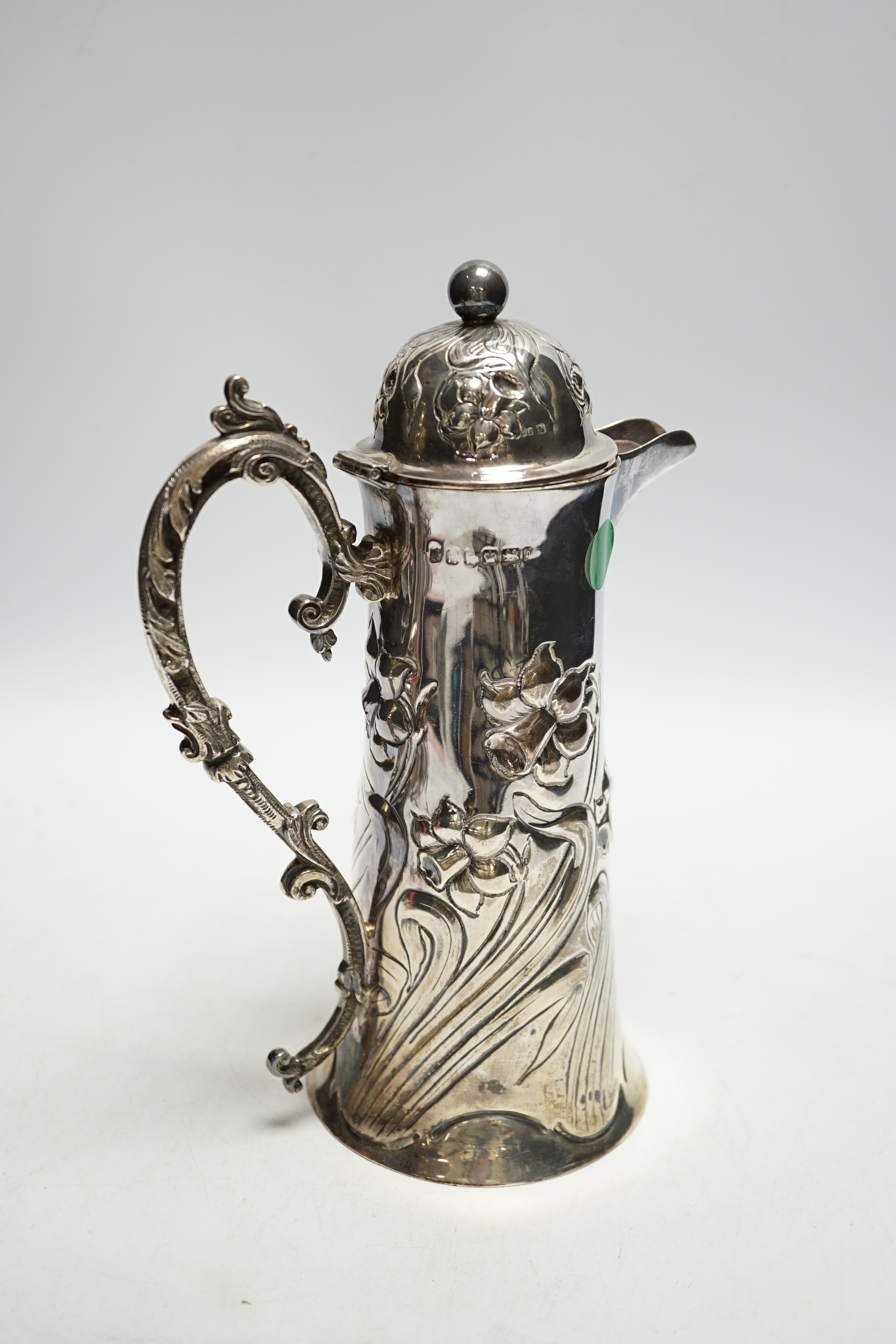 A late Victorian embossed silver jug, John Henry Potter, Sheffield, 1900, height 24.8cm, with replaced plated handle?, gross weight 22.6oz.